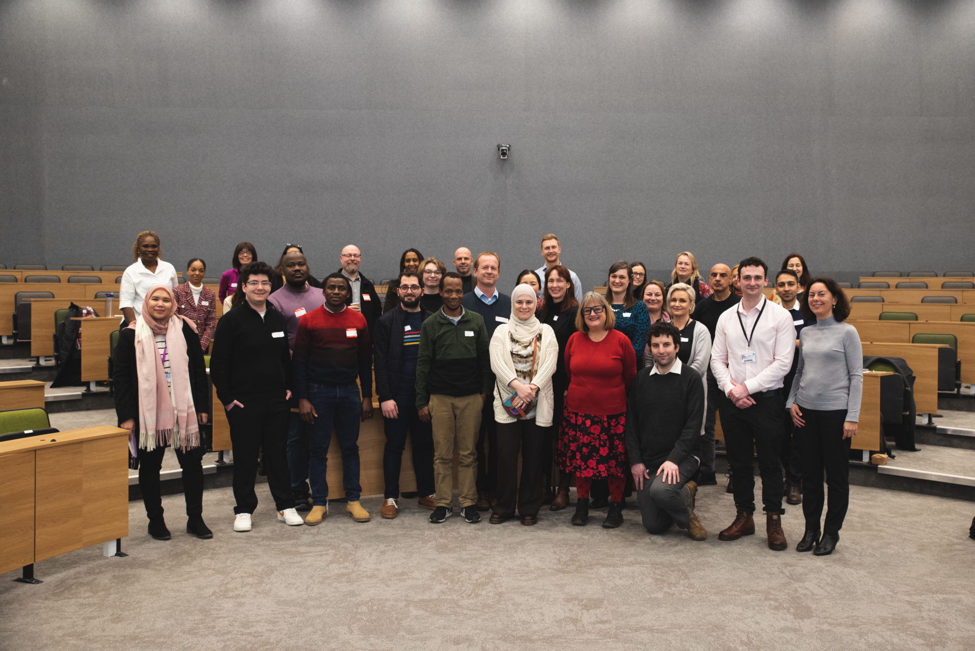 Conference attendees and speaker pictured together in lecture hall